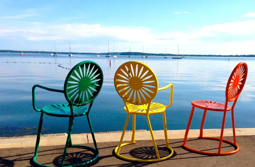 Green, yellow and orange Memorial Union Terrace sunburst chairs on a Madison Lake