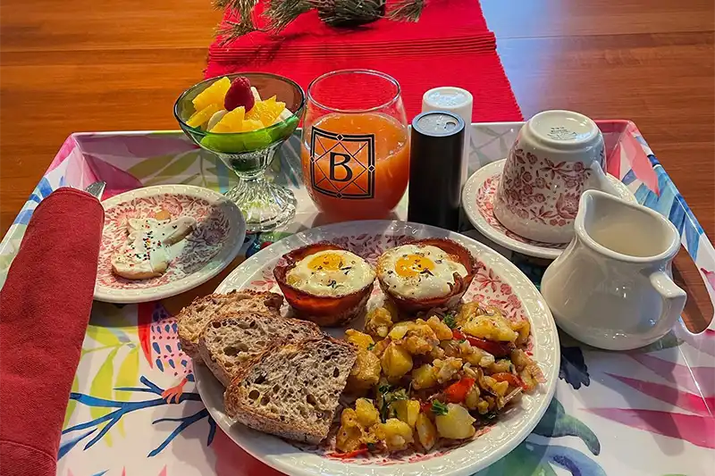 Gourmet homemade breakfast at The Buckingham Inn bed and breakfast in Madison WI, featuring egg cups, roasted potatoes, and fresh fruit.