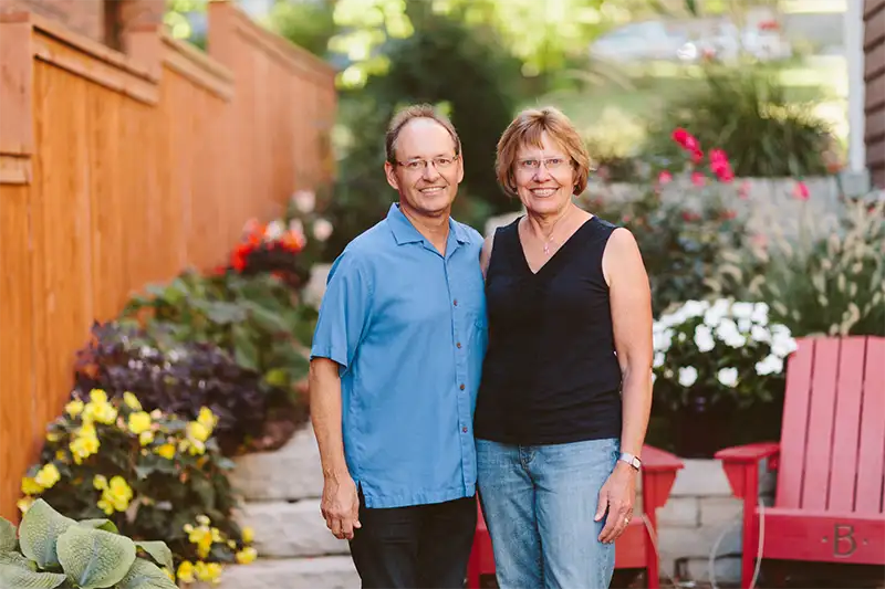 Heidi and Tom Notbohm, the friendly innkeepers of The Buckingham Inn bed and breakfast, standing in their beautiful garden in Madison, Wisconsin.