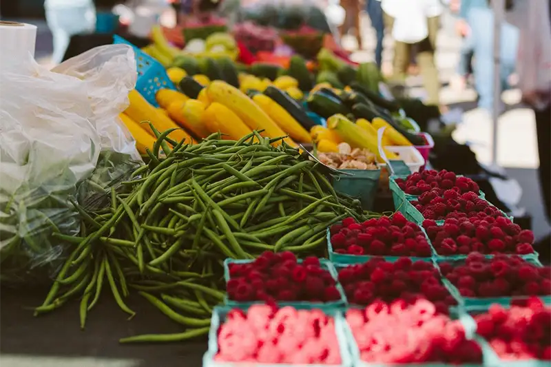 Fresh green beans and raspberries at the Dane County Farmers' Market on the Capitol Square, where we source local ingredients for The Buckingham Inn breakfast.